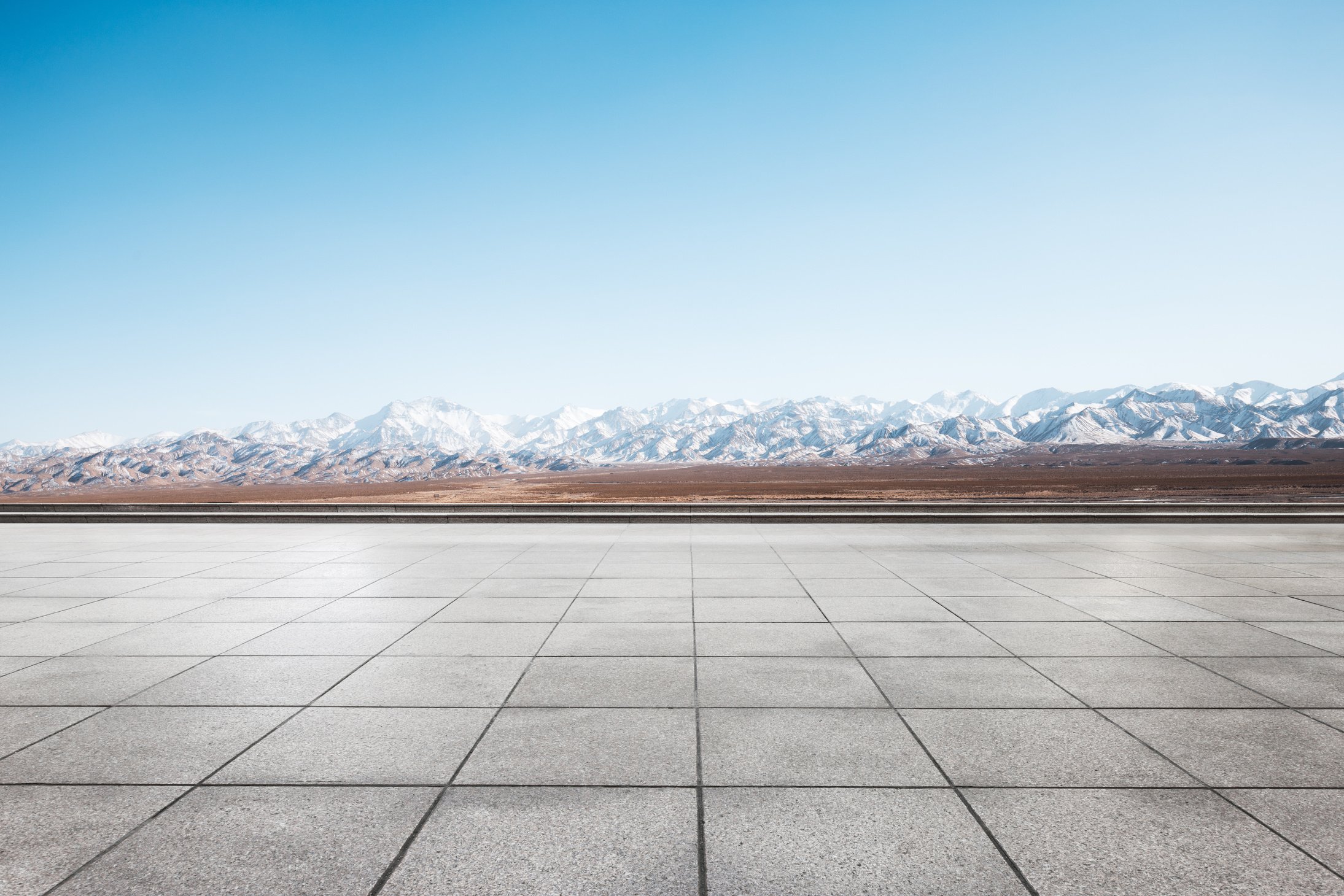 empty floor with white snow mountains